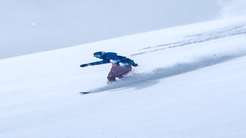 Skier riding through deep powder snow.