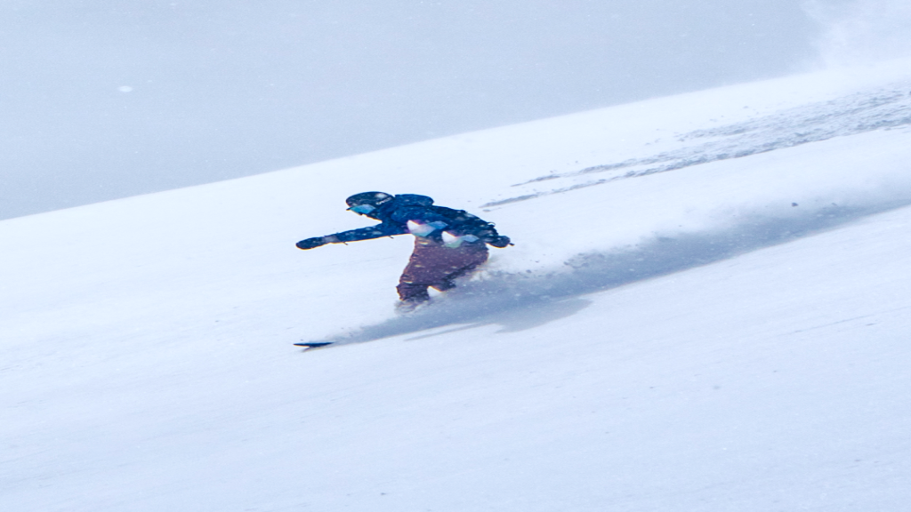 Skier riding through deep powder snow.