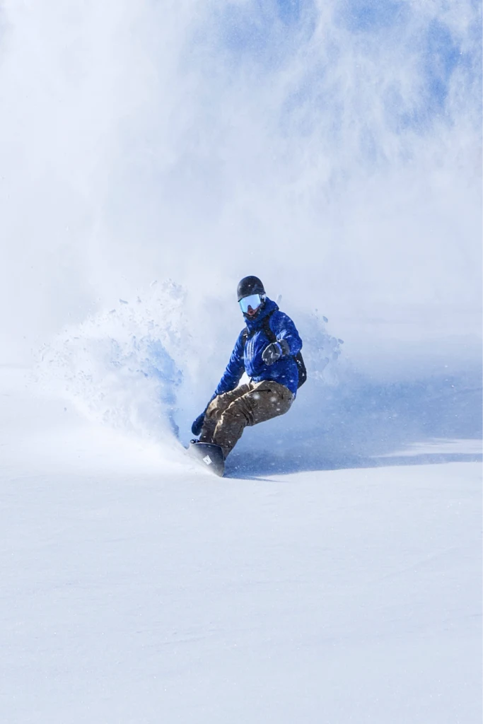 Skier riding through deep powder snow.